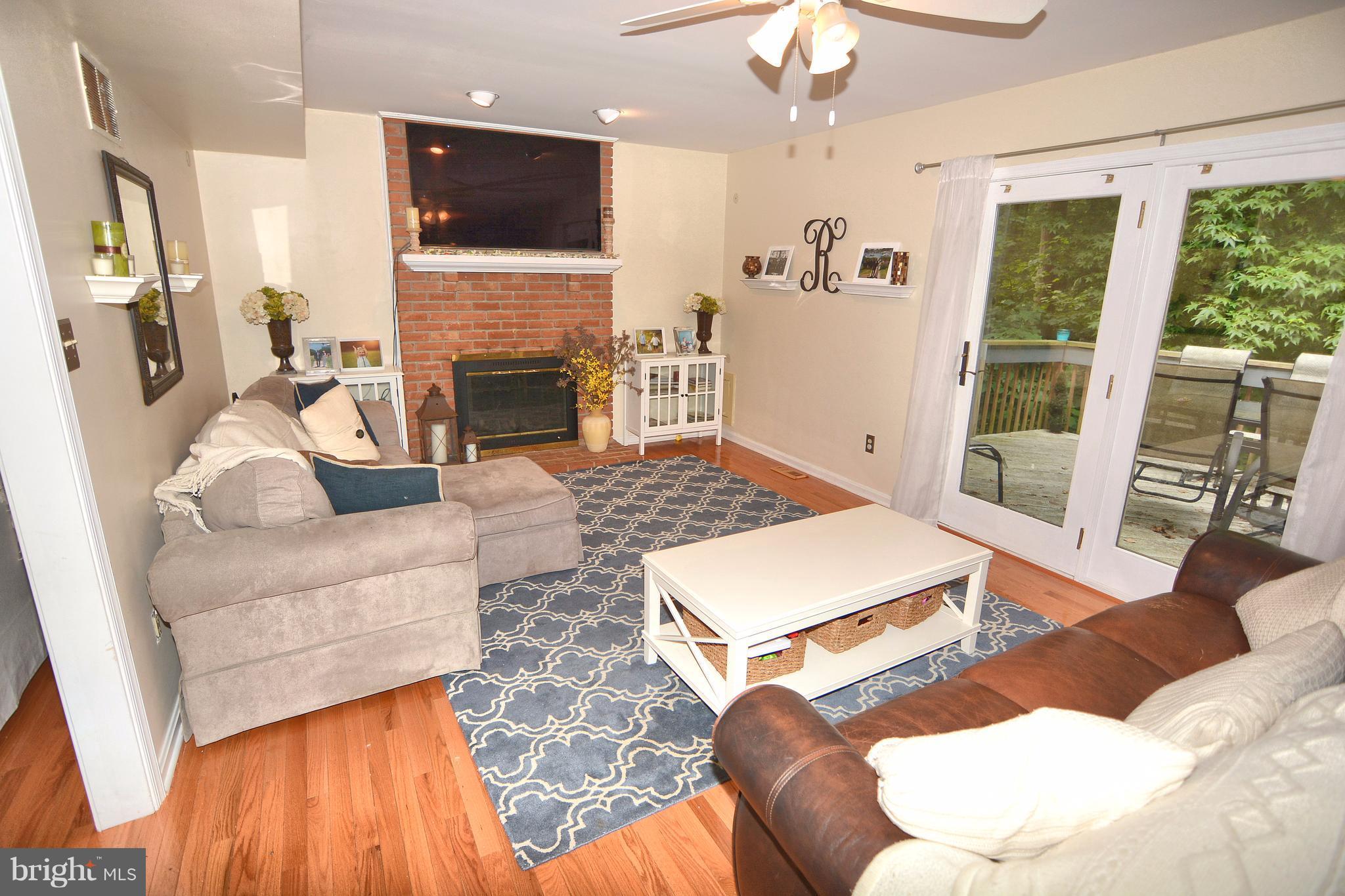 290 Locust Ridge Lane Arnold, MD 21012 - Photo 4 of 30 Family Room with wood floors and masonry FP