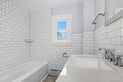 a bathroom with sink bathtub and shower