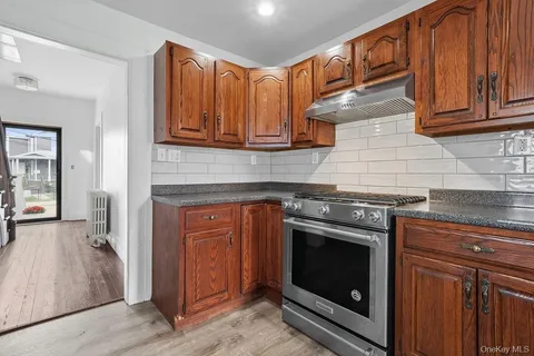 a kitchen with stainless steel appliances granite countertop a stove and a microwave