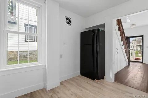 an empty room with windows and closet