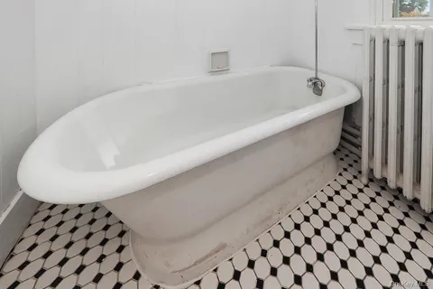 a bathroom with a bathtub and a sink