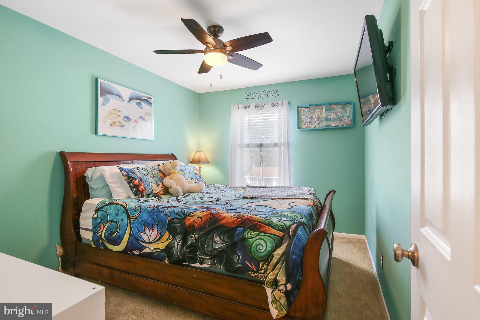 2053 Putnam Road Baltimore, MD 21227 - Photo 13 of 21 a bedroom with a bed and a chandelier