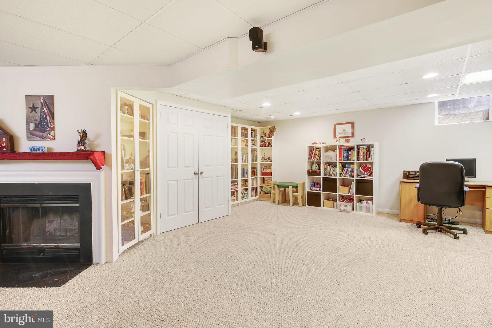 2053 Putnam Road Baltimore, MD 21227 - Photo 5 of 21 a view of a livingroom with a fireplace and workspace