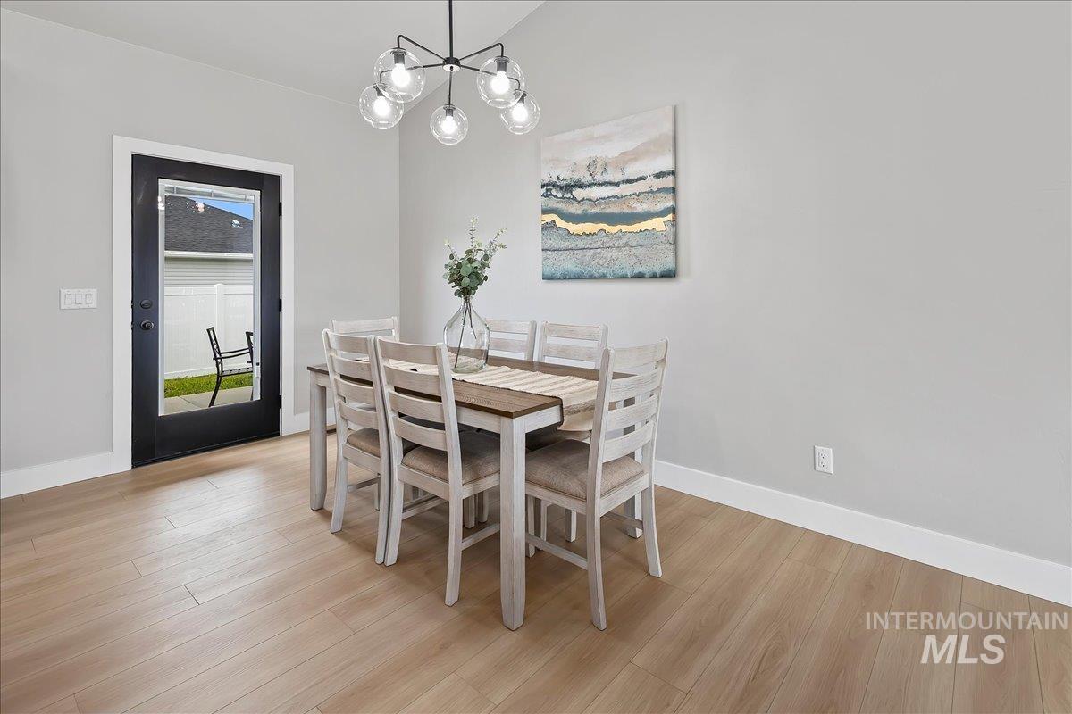 1201 Jade Drive Rupert, ID 83350 - Photo 6 of 27 Light wood-finish flooring complements the neutral wall color in this dining area