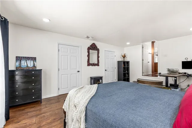 a bedroom with a bed and a dresser