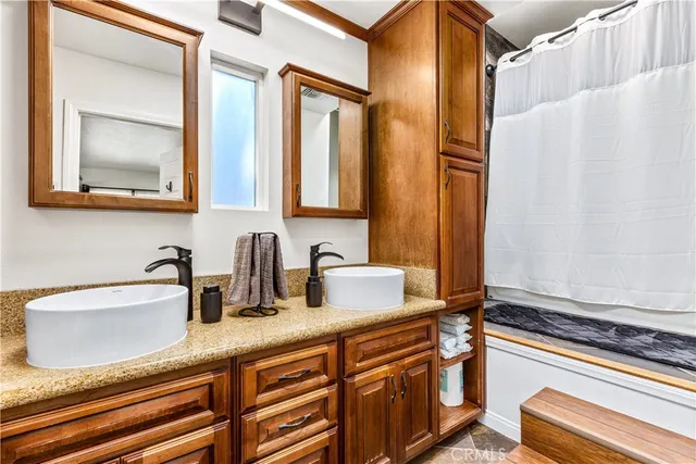 a bathroom with a sink a mirror and a bathtub