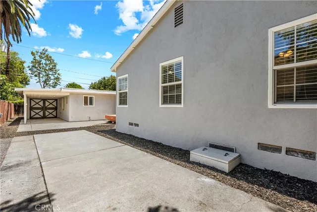 a backyard of a house with table and chairs