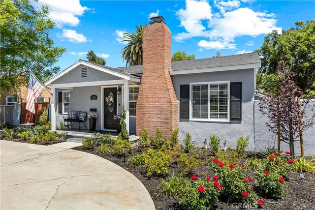 a front view of a house with a garden