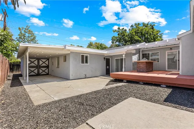 a view of a house with a backyard and porch