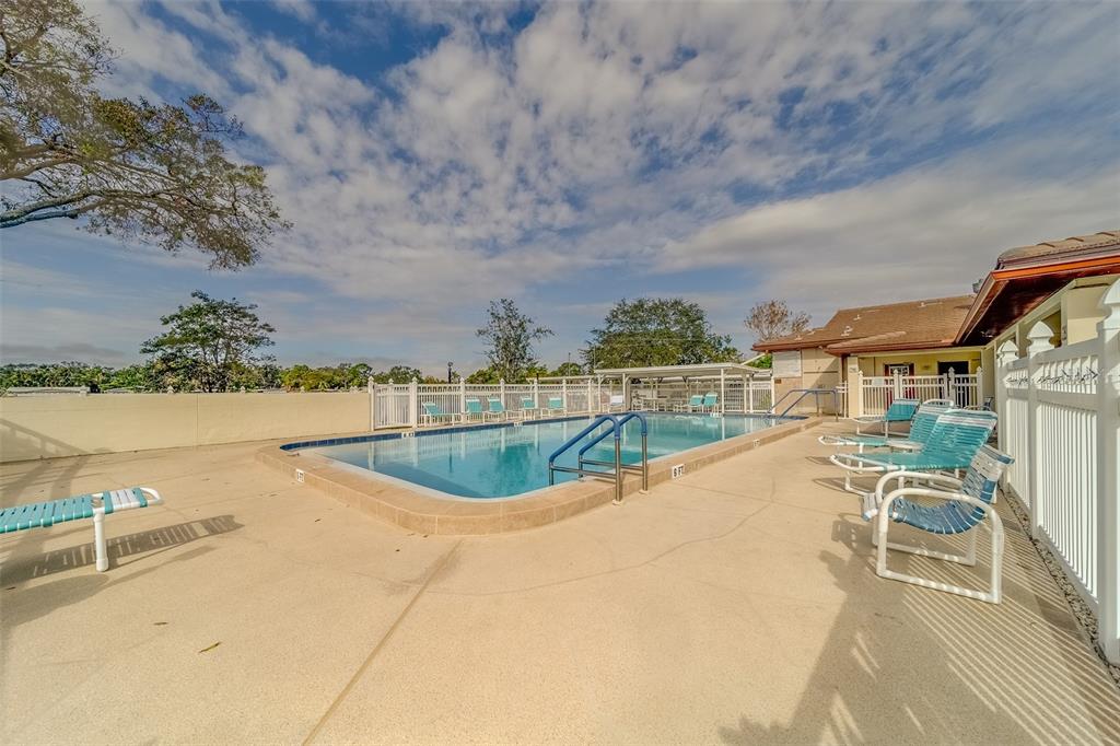 12501 Ulmerton Road, Unit 188 Largo, FL 33774 - Photo 41 of 63 a view of a swimming pool with an outdoor seating
