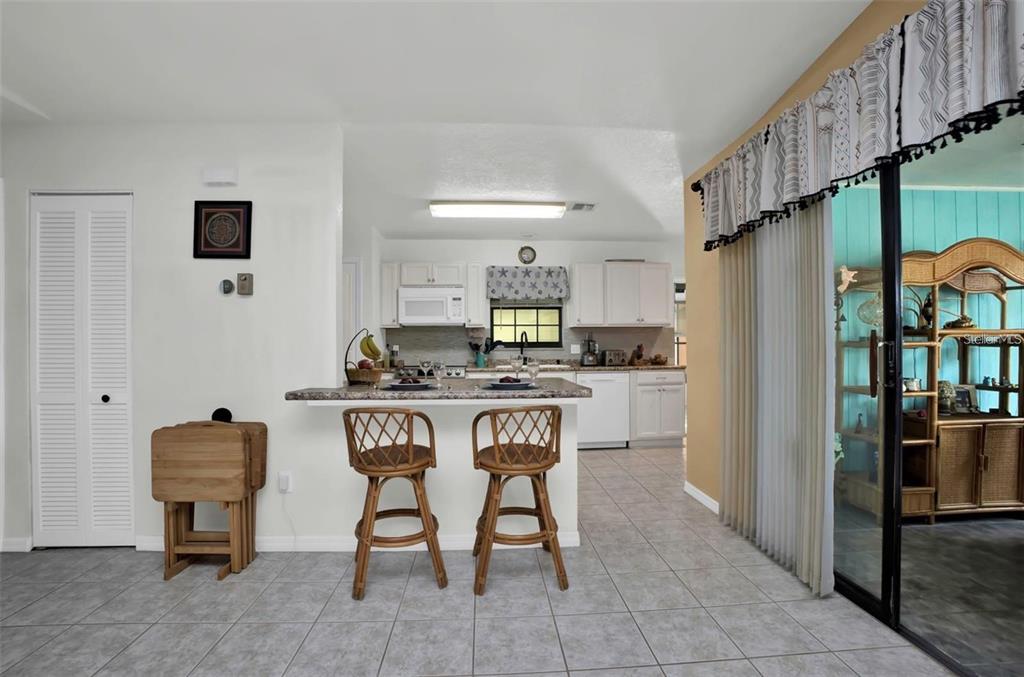 3520 Kenneth Road Port Charlotte, FL 33953 - Photo 11 of 43 a kitchen with stainless steel appliances a refrigerator and a stove