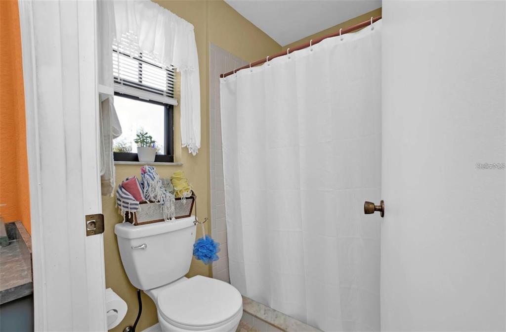 3520 Kenneth Road Port Charlotte, FL 33953 - Photo 17 of 43 a white toilet sitting next to a bathroom sink
