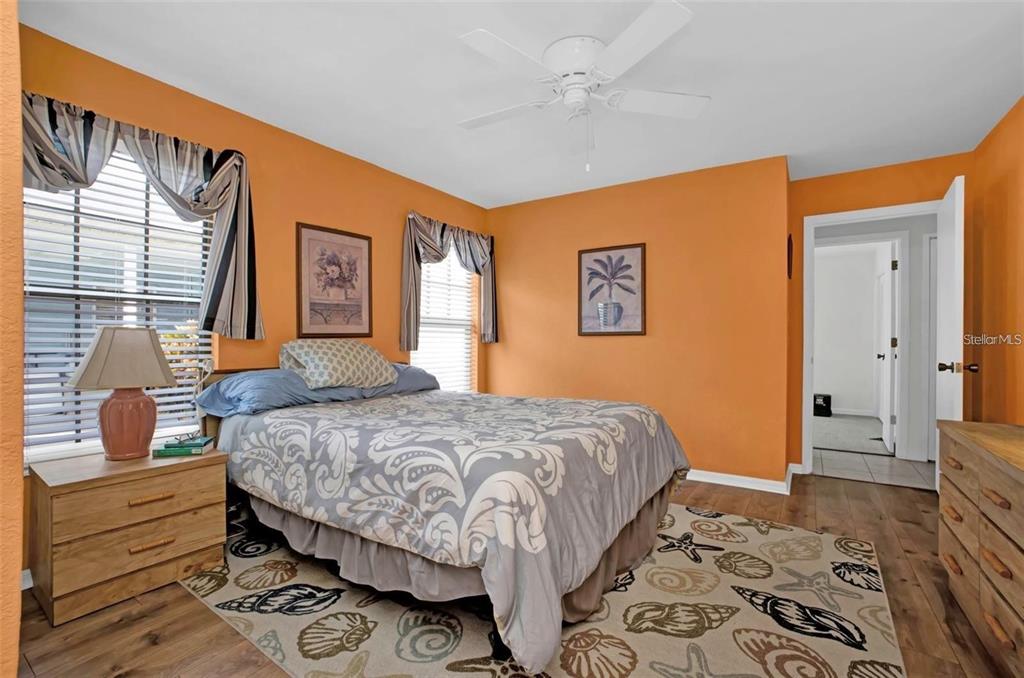 3520 Kenneth Road Port Charlotte, FL 33953 - Photo 19 of 43 a bedroom with a bed and wooden floor