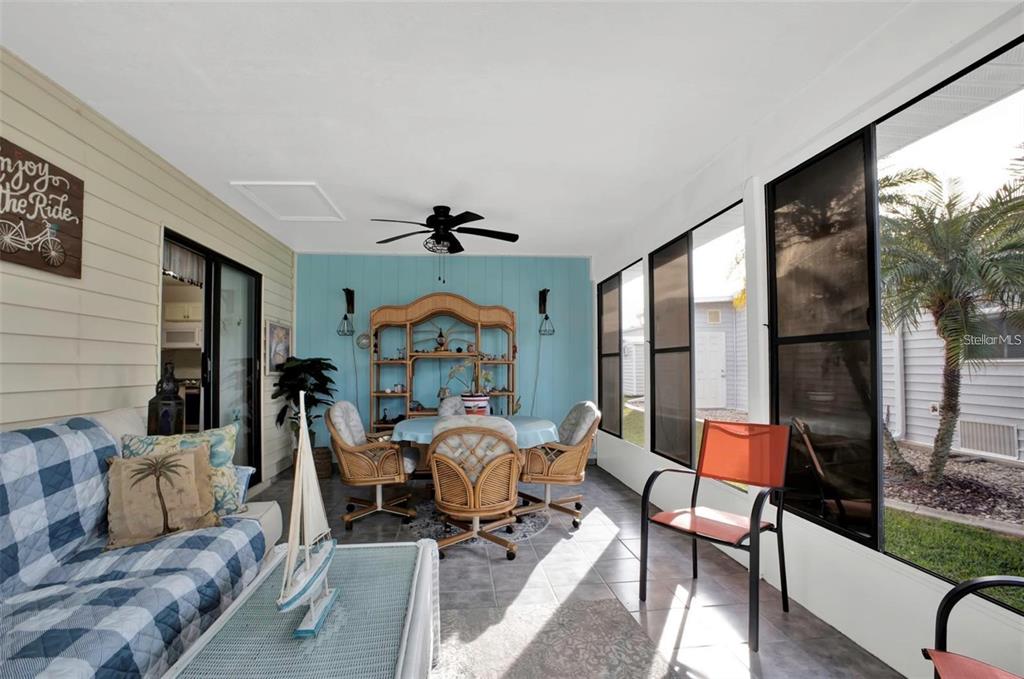 3520 Kenneth Road Port Charlotte, FL 33953 - Photo 24 of 43 a living room with furniture a rug potted plant and a large window