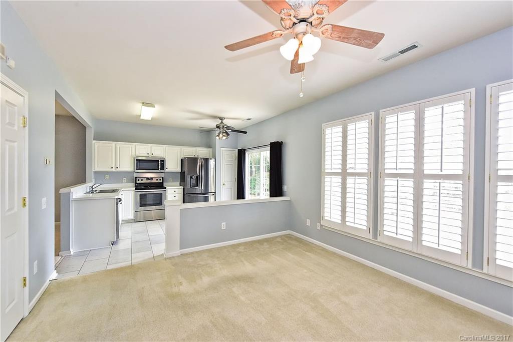15319 McClure Bridge Road, Unit L90 Charlotte, NC 28277 - Photo 11 of 19 a view of a kitchen with furniture ceiling fan and windows