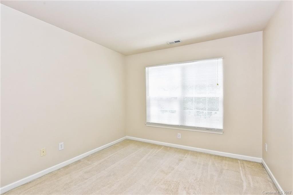 15319 McClure Bridge Road, Unit L90 Charlotte, NC 28277 - Photo 17 of 19 an empty room with a window