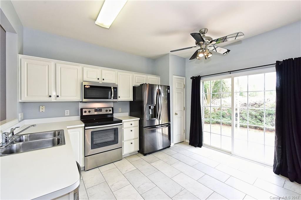 15319 McClure Bridge Road, Unit L90 Charlotte, NC 28277 - Photo 7 of 19 a kitchen with stainless steel appliances a refrigerator sink and stove