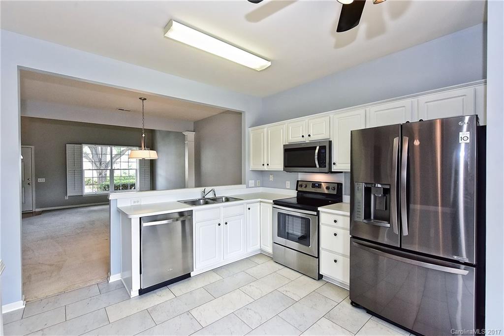 15319 McClure Bridge Road, Unit L90 Charlotte, NC 28277 - Photo 8 of 19 a kitchen with stainless steel appliances granite countertop a refrigerator sink and stove