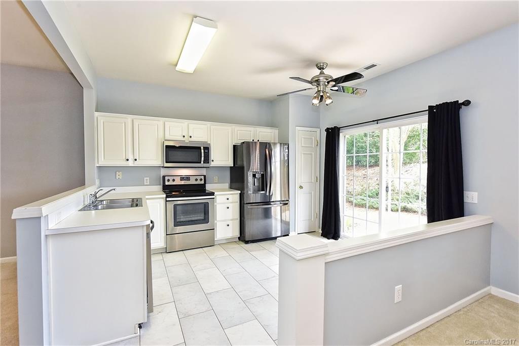 15319 McClure Bridge Road, Unit L90 Charlotte, NC 28277 - Photo 9 of 19 a kitchen with a stove a microwave and refrigerator