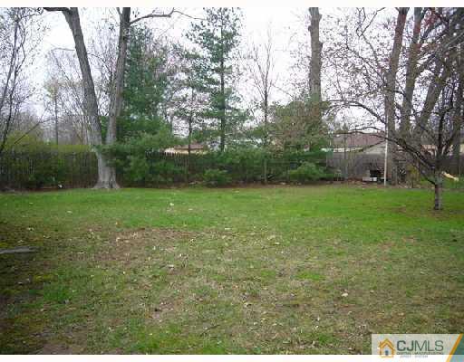 23 Kenmore Road Edison, NJ 08817 - Photo 2 of 8 a view of a grassy field with trees