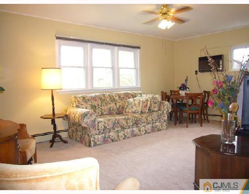 23 Kenmore Road Edison, NJ 08817 - Photo 3 of 8 a living room with furniture and a flat screen tv