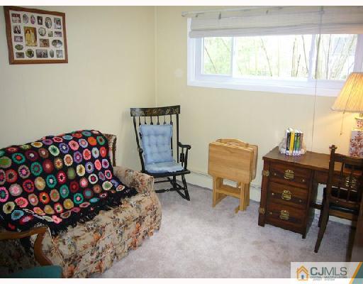 23 Kenmore Road Edison, NJ 08817 - Photo 5 of 8 a bedroom with a bed and a window