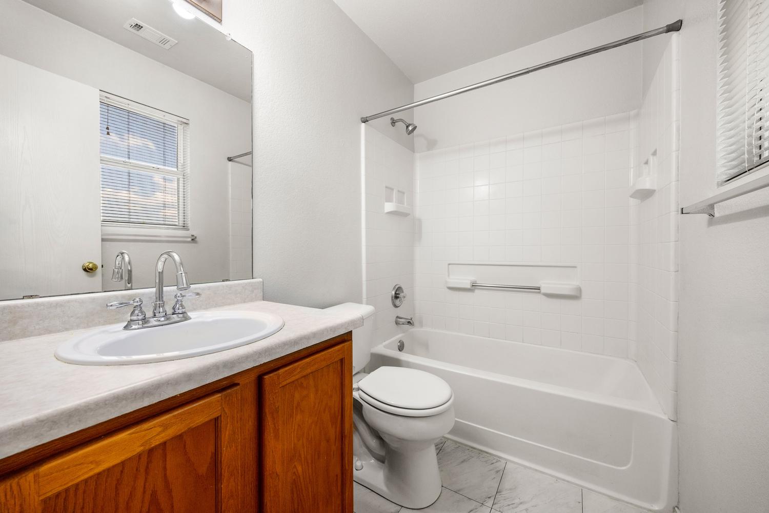 359 Spring Branch Loop Kyle, TX 78640 - Photo 13 of 17 a bathroom with a sink a toilet and shower