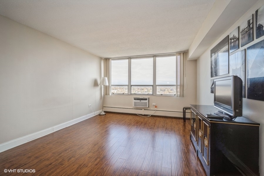 8801 West Golf Road, Unit 10E Niles, IL 60714 - Photo 15 of 21 a view of workspace with wooden floor and windows