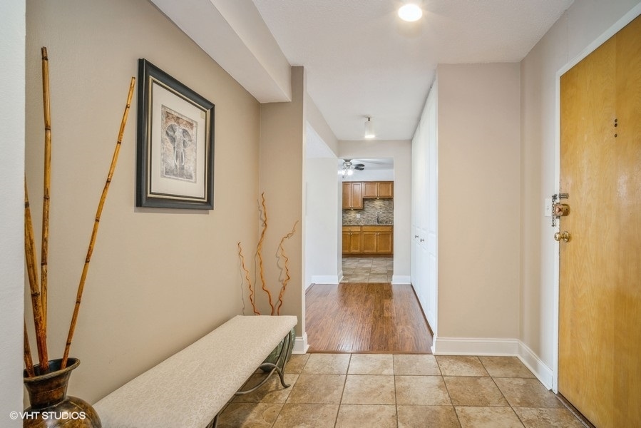 8801 West Golf Road, Unit 10E Niles, IL 60714 - Photo 3 of 21 a bathroom with a tub shower and a sink