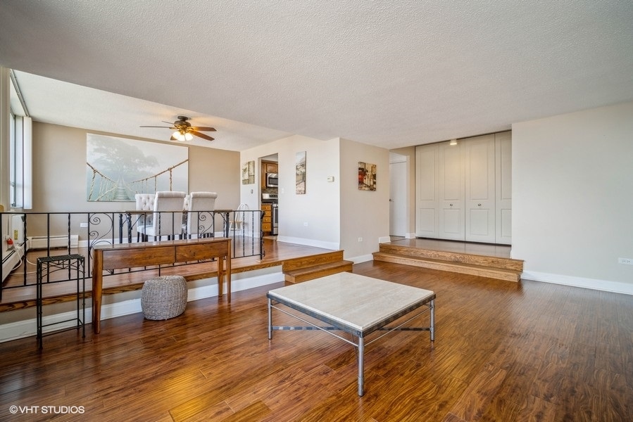 8801 West Golf Road, Unit 10E Niles, IL 60714 - Photo 4 of 21 a living room with furniture and a wooden floor