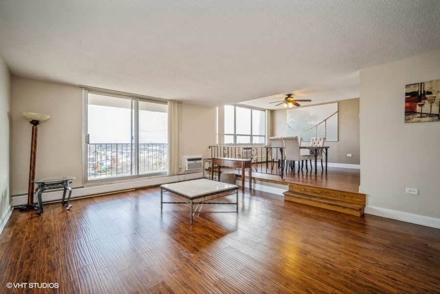8801 West Golf Road, Unit 10E Niles, IL 60714 - Photo 5 of 21 a living room with furniture and a table