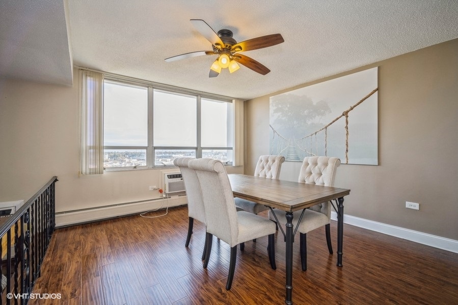 8801 West Golf Road, Unit 10E Niles, IL 60714 - Photo 6 of 21 a view of a dining room with furniture window and wooden floor
