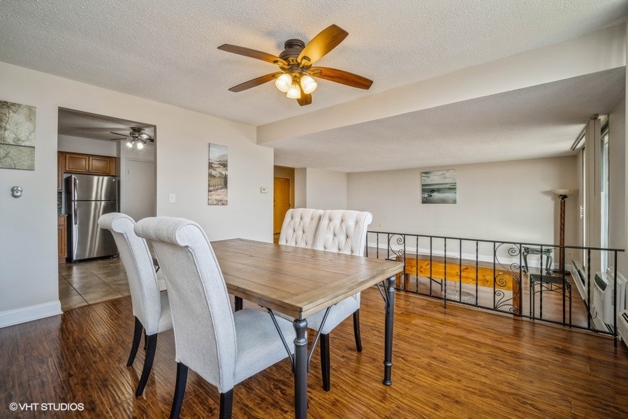 8801 West Golf Road, Unit 10E Niles, IL 60714 - Photo 8 of 21 a view of a dining room with furniture and wooden floor