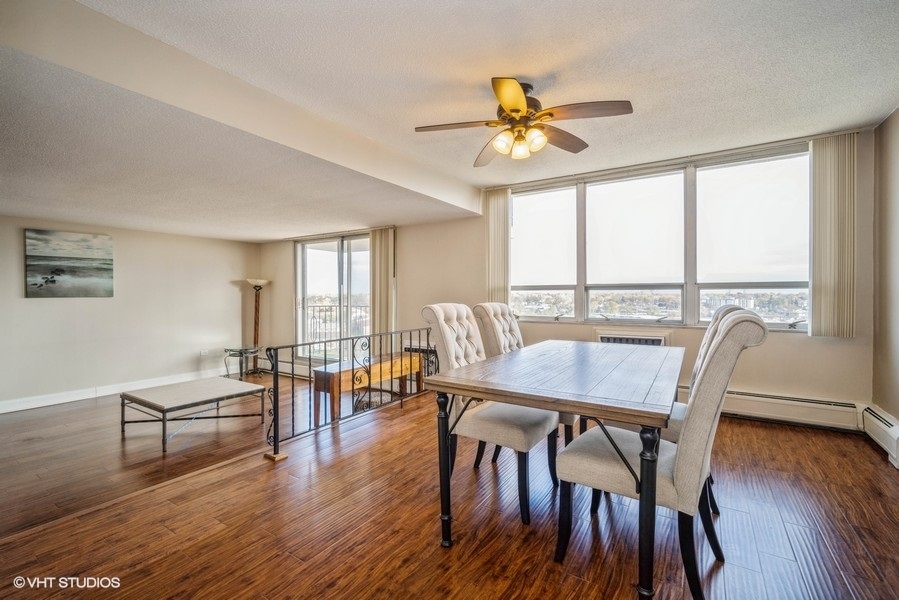 8801 West Golf Road, Unit 10E Niles, IL 60714 - Photo 9 of 21 a view of a dining room with furniture window and wooden floor