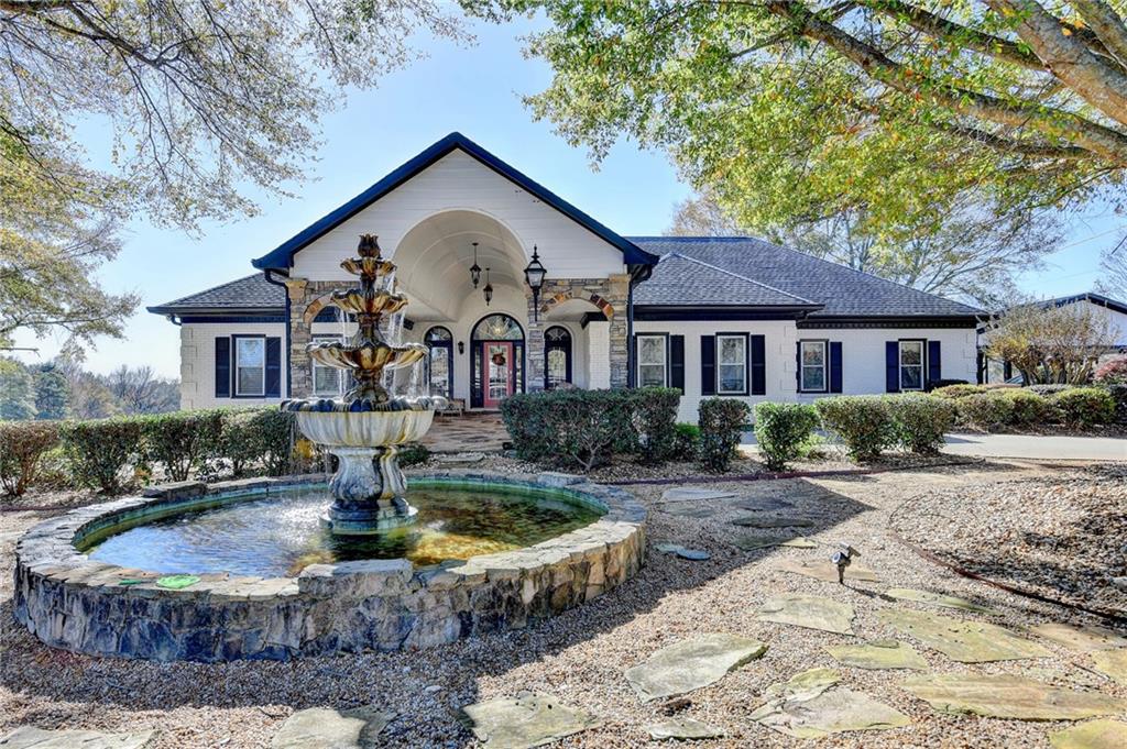 4420 Benefield Road Braselton, GA 30517 - Photo 11 of 34 a front view of a house with garden
