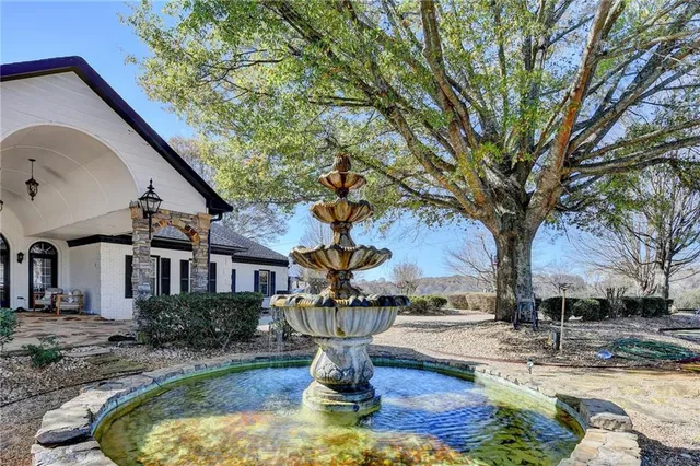 a living room with furniture a fireplace and wooden floor