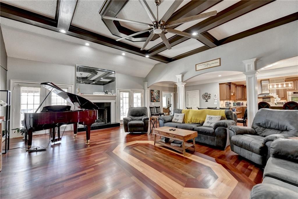 4420 Benefield Road Braselton, GA 30517 - Photo 14 of 34 a living room with furniture a fireplace and wooden floor