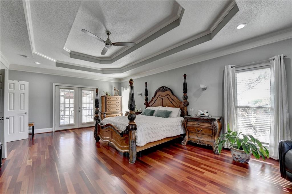 4420 Benefield Road Braselton, GA 30517 - Photo 19 of 34 a living room with furniture a wooden floor and a chandelier