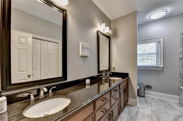 a living room with furniture and painting on the wall