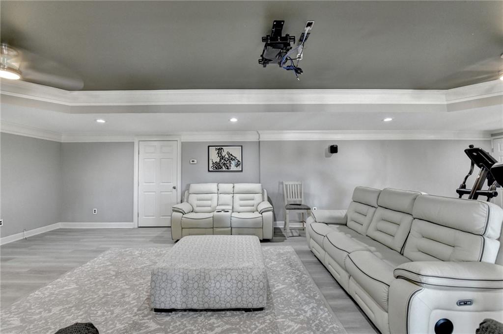 4420 Benefield Road Braselton, GA 30517 - Photo 24 of 34 a living room with furniture and painting on the wall