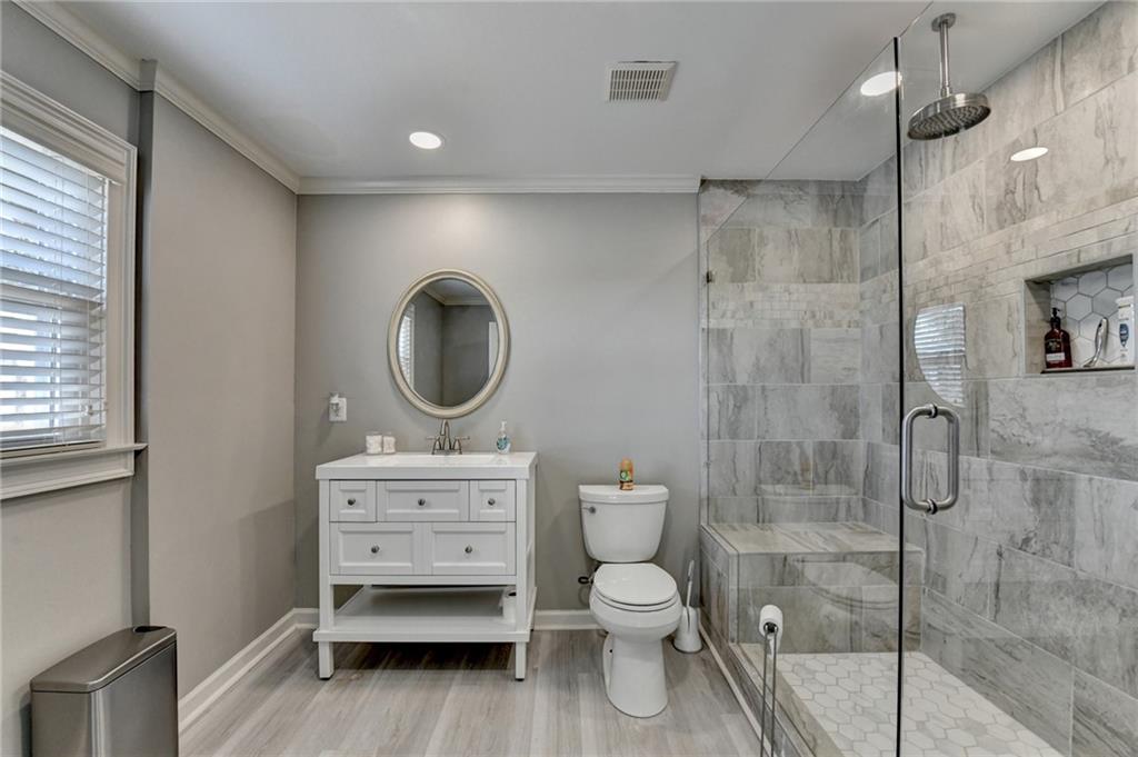 4420 Benefield Road Braselton, GA 30517 - Photo 27 of 34 a bathroom with a sink toilet a mirror and shower