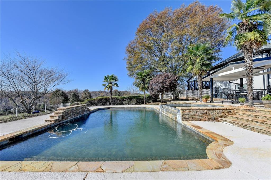 4420 Benefield Road Braselton, GA 30517 - Photo 28 of 34 a view of a swimming pool with a lounge chair