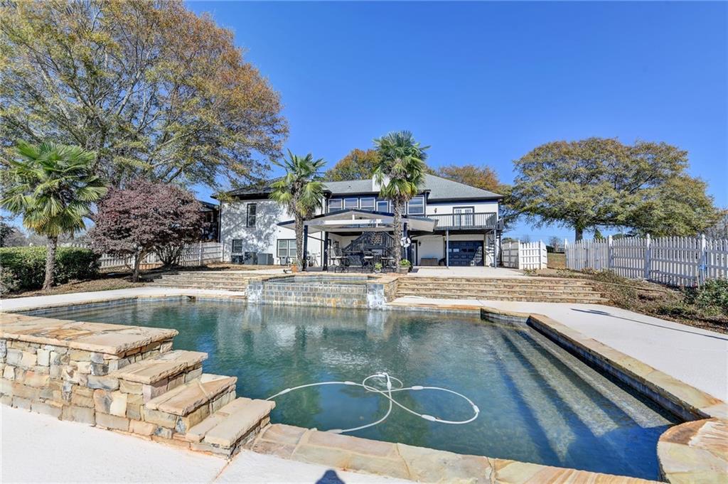 4420 Benefield Road Braselton, GA 30517 - Photo 29 of 34 a view of a swimming pool with a lounge chairs