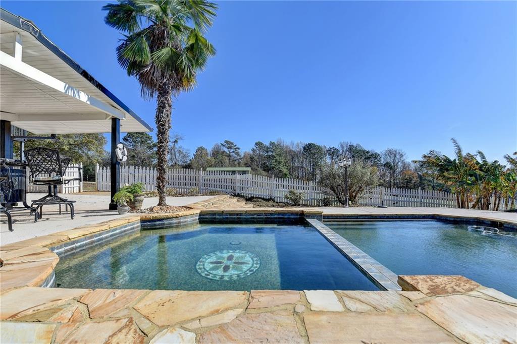 4420 Benefield Road Braselton, GA 30517 - Photo 30 of 34 a view of a swimming pool and lounge chair