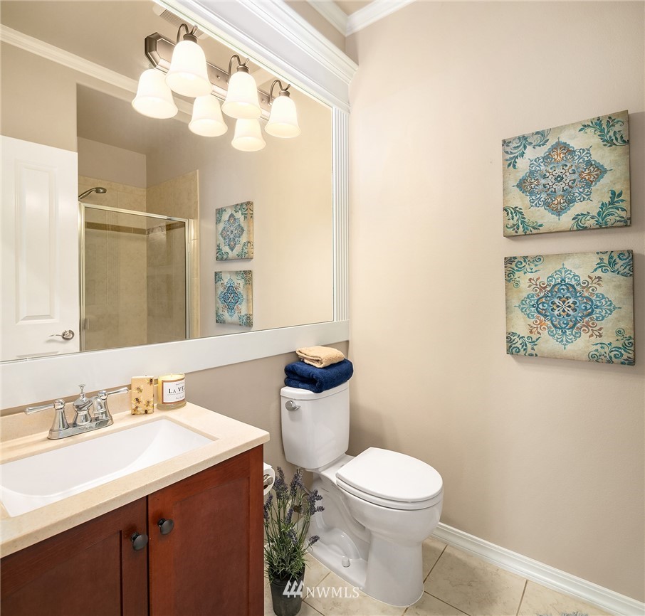 3930 215th Street Southeast Bothell, WA 98021 - Photo 17 of 35 a bathroom with a toilet a sink and mirror