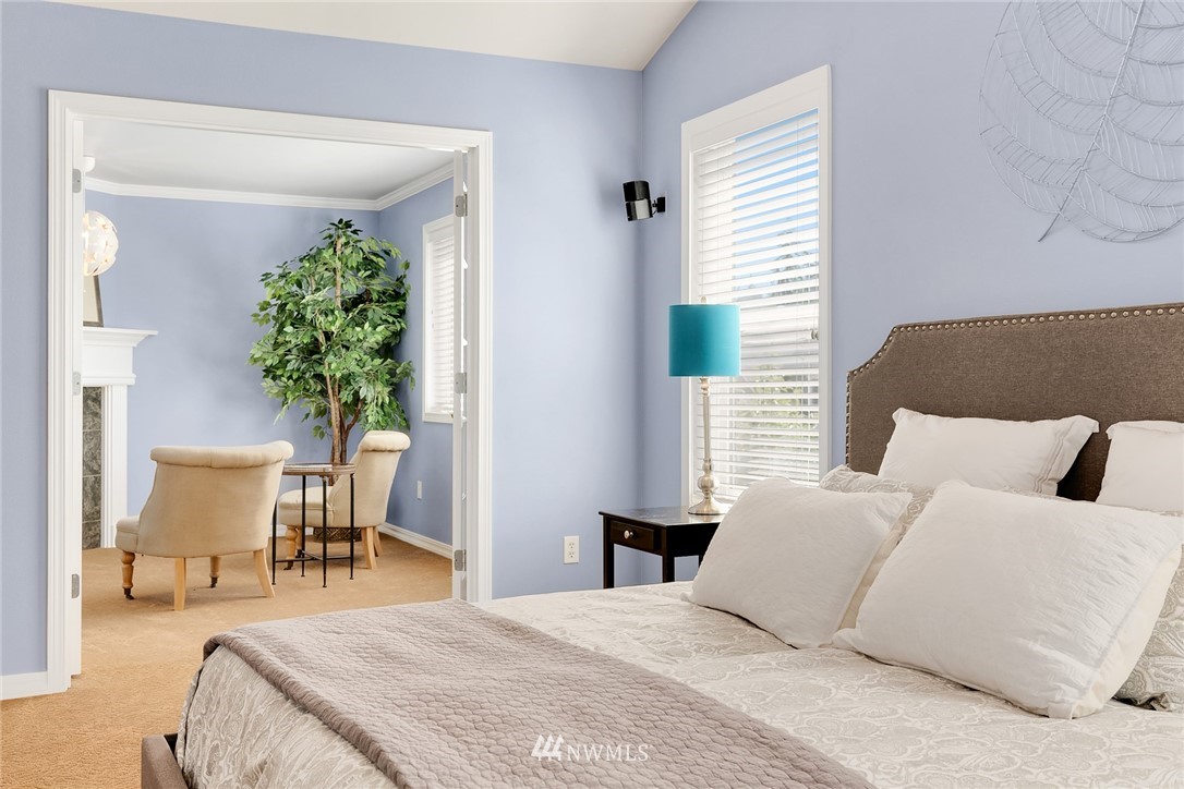 3930 215th Street Southeast Bothell, WA 98021 - Photo 20 of 35 a bedroom with a bed table chair and a potted plant