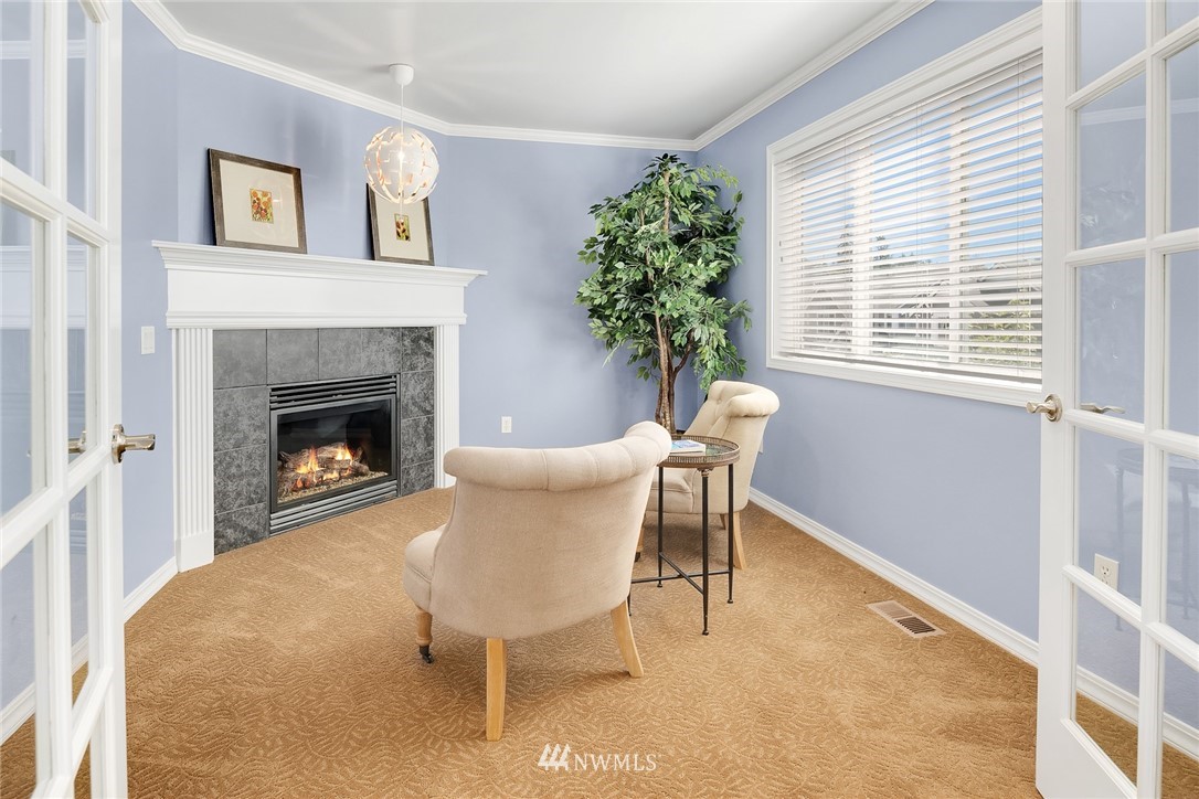 3930 215th Street Southeast Bothell, WA 98021 - Photo 21 of 35 a living room with furniture and a fireplace