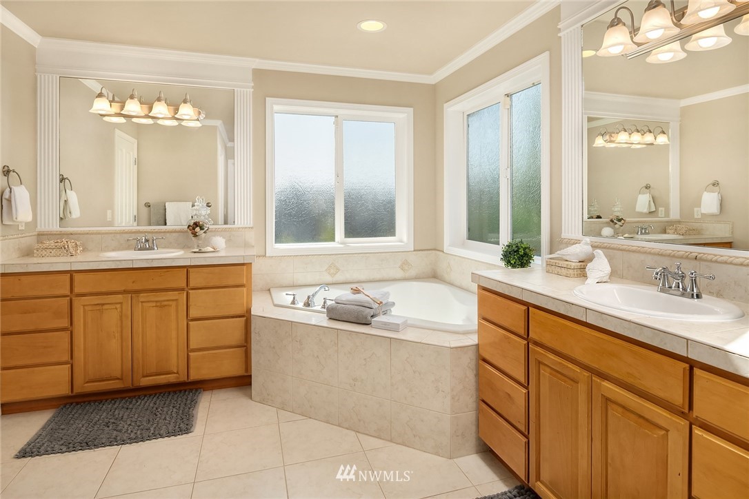 3930 215th Street Southeast Bothell, WA 98021 - Photo 22 of 35 a bathroom with a granite countertop sink mirror bathtub and double