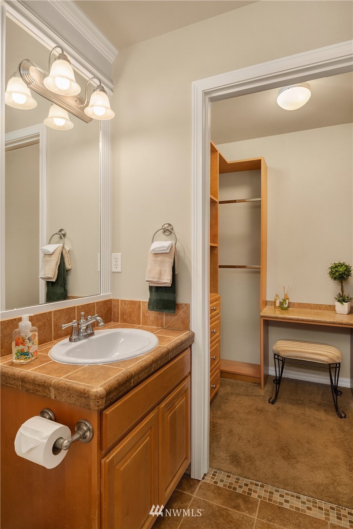 3930 215th Street Southeast Bothell, WA 98021 - Photo 28 of 35 a bathroom with a sink vanity and a mirror