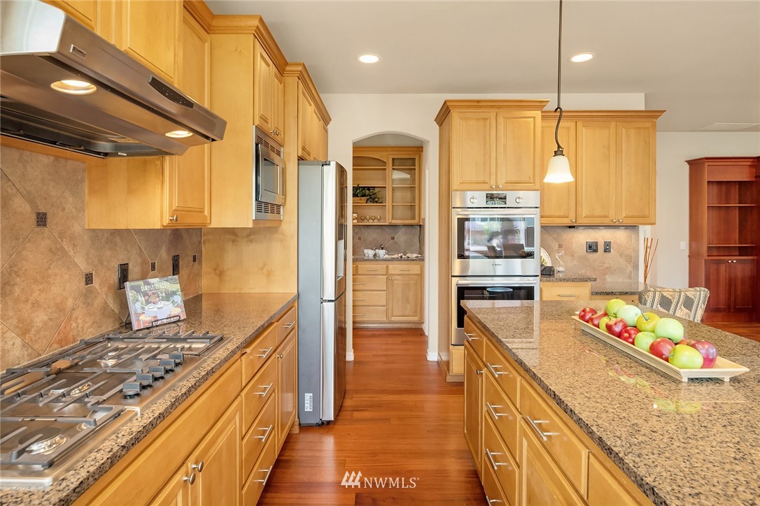3930 215th Street Southeast Bothell, WA 98021 - Photo 10 of 35 a kitchen with kitchen island granite countertop lots of counter top space and stainless steel appliances